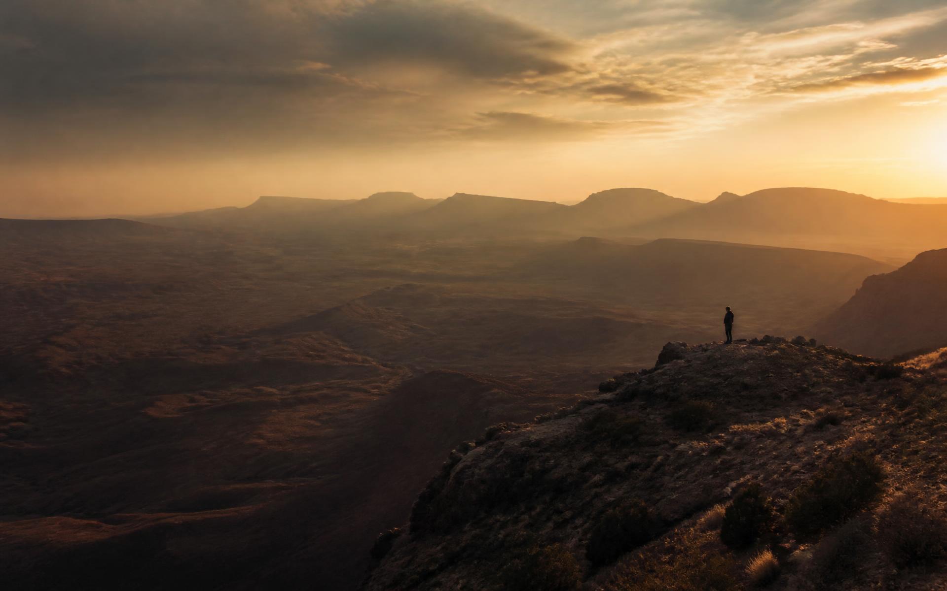 A lone figure overlooking the desert near St. George, Utah at sunrise